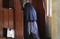 In this Sunday, Nov. 4, 2018, photo, a nun partakes in the sacrament of confession at the Immaculate Heart of Mary Cathedral in Kottayam in the southern Indian state of Kerala. An AP investigation has uncovered a decades-long history of nuns in India enduring sexual abuse from within the Catholic church. (AP Photo/Manish Swarup)