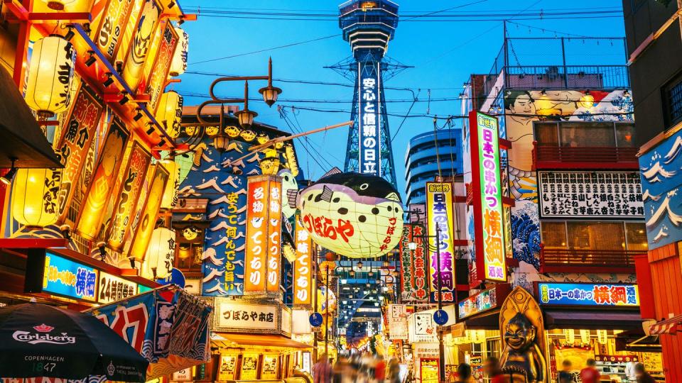 osaka tower and view of the neon advertisements shinsekai district