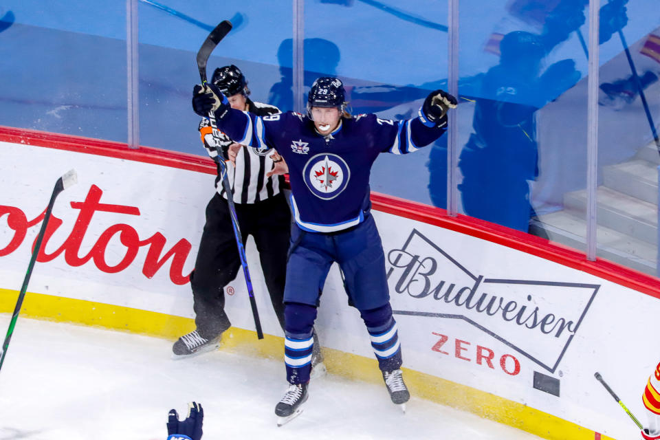 WINNIPEG, MB - JANUARY 14: Patrik Laine #29 of the Winnipeg Jets celebrates after scoring the overtime winner for a 4-3 victory over the Calgary Flames at the Bell MTS Place on January 14, 2021 in Winnipeg, Manitoba, Canada. (Photo by Darcy Finley/NHLI via Getty Images)