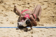 Anouk Verge-Depre, right, of Switzerland, and teammate Joana Heidrich celebrate winning a women's beach volleyball match against Brazil at the 2020 Summer Olympics, Tuesday, Aug. 3, 2021, in Tokyo, Japan.