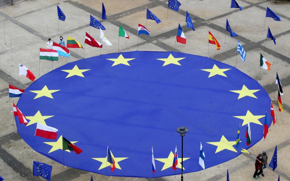 A large European Union flag lies at the centre of Schuman square, outside the European Commission headquarters