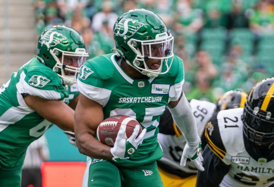 Saskatchewan Roughriders running back Jamal Morrow (25) runs the football against Hamilton Tiger-Cats during first half CFL football action in Regina on Saturday, June 11, 2022. 