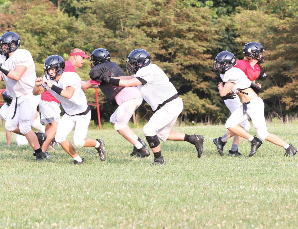 The Rosecrans offense works on a running play during its practice on Wednesday. The Bishops return plenty of experience and aim to improve on a 3-8 campaign a year ago.