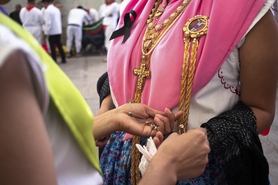 People get ready to perform at the start of the Guelaguetza festival in Oaxaca, Mexico, Monday, July 17, 2023. During the government-sponsored event, 16 Indigenous ethnic groups and the Afro-Mexican community promote their traditions through public dances, parades and craft sales. (AP Photo/Maria Alferez)