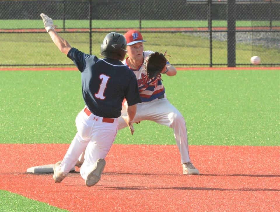 Norwich's Anthony Martin slides into second base as Waterford shortstop Evan McCue waits for the throw Wednesday at Mitchell College in New London.