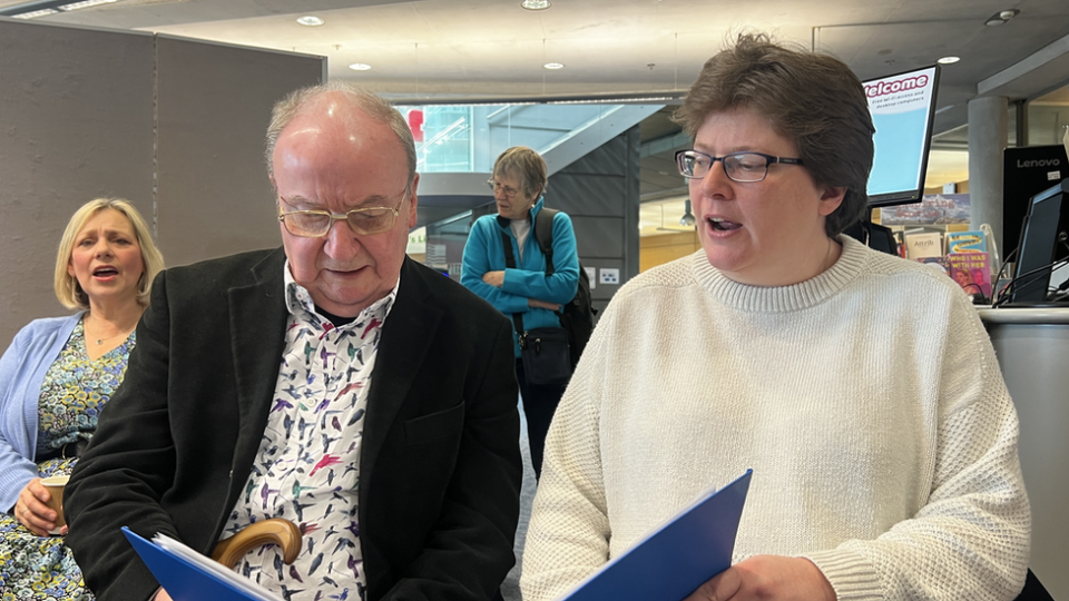 Neil Croft sitting next to his wife in the choir