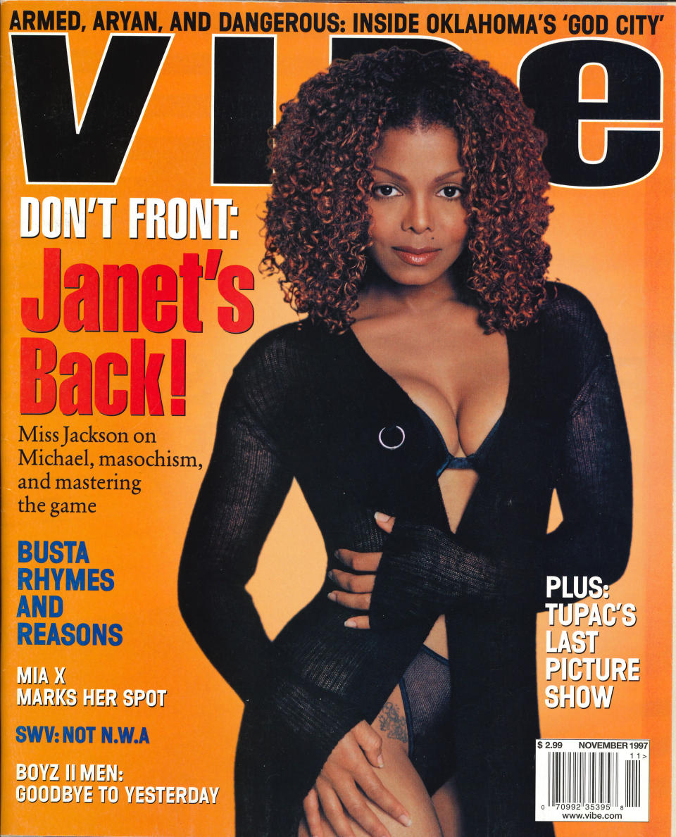 Janet Jackson in a black bra, panties, and cover up on VIBE's November 1997 issue