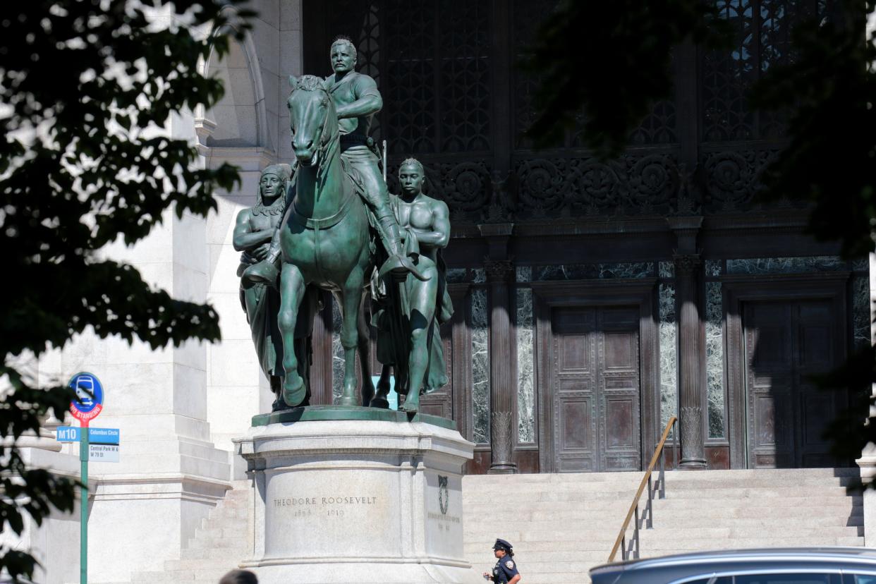 New York - June 22, 2020 - NYPD officers are seen guarding the equestrian Statue of Theodore Roosevelt, a 1939 bronze sculpture by James Earle Fraser outside the American Museum of Natural History. On Sunday Mayor Bill de Blasio and the American Museum of Natural History announced that they will remove the prominent statue of Theodore Roosevelt from its entrance after years of objections that it symbolizes colonial expansion and racial discrimination. The bronze statue that has stood at the museum's Central Park West entrance since 1940 depicts Roosevelt on horseback with a Native American man and an African man standing next to the horse. (Luiz C. Ribeiro for New York Daily News) 