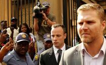 Olympic and Paralympic track star Oscar Pistorius (C) leaves at the end of his trial for the murder of his girlfriend Reeva Steenkamp, at the North Gauteng High Court in Pretoria, March 18, 2014. Pistorius is on trial for murdering his girlfriend Reeva Steenkamp at his suburban Pretoria home on Valentine's Day last year. He says he mistook her for an intruder. REUTERS/Siphiwe Sibeko (SOUTH AFRICA - Tags: CRIME LAW SPORT ATHLETICS)