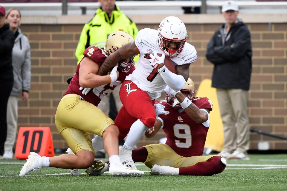 Louisville running back Tiyon Evans, 7, is tackled by Boston College linebacker Vinny DePalma, 42, and defensive back Jaiden Woodbey, 9, last October at Alumni Stadium.