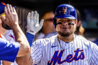 New York Mets' Daniel Vogelbach high-ives teammates in the dugout after hitting a home run during the sixth inning of a baseball game against the Philadelphia Phillies, Sunday, Aug. 14, 2022, in New York. (AP Photo/Julia Nikhinson)