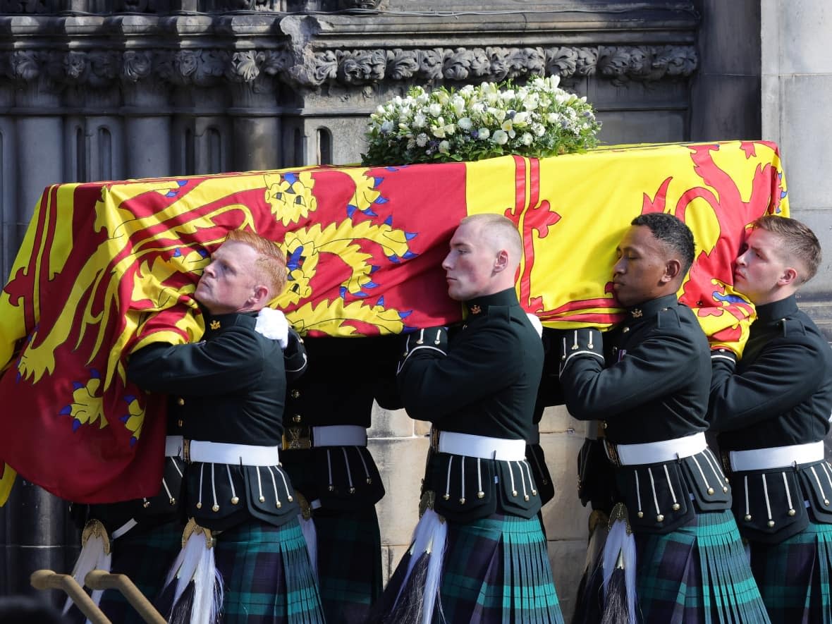 The coffin of Queen Elizabeth is carried into St Giles' Cathedral, after making its way along the Royal Mile, on Monday in Edinburgh. (Chris Jackson/Getty Images - image credit)