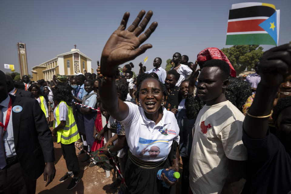 People in the crowd cheer and wave as Pope Francis is wheeled past after addressing clergy at the St. Theresa Cathedral in Juba, South Sudan, Saturday, Feb. 4, 2023. Pope Francis is in South Sudan on the second leg of a six-day trip that started in Congo, hoping to bring comfort and encouragement to two countries that have been riven by poverty, conflicts and what he calls a "colonialist mentality" that has exploited Africa for centuries. (AP Photo/Ben Curtis)