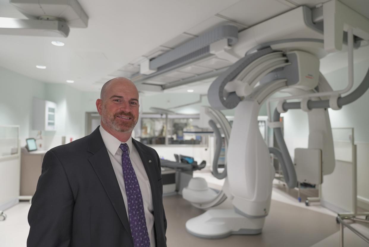 Dr. James McKinney, medical director of the Novant Health Neurosciences Institute in the Coastal region, stands in a procedure room inside the new Novant Health Neurosciences Institute - New Hanover.