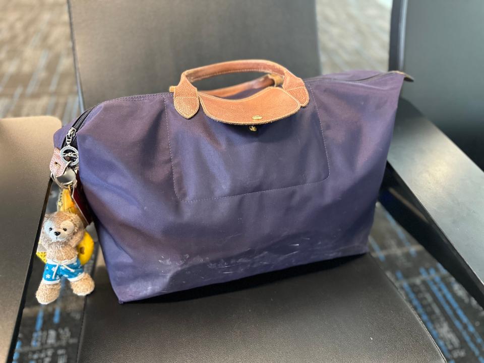 Small personal item bag on airport sea