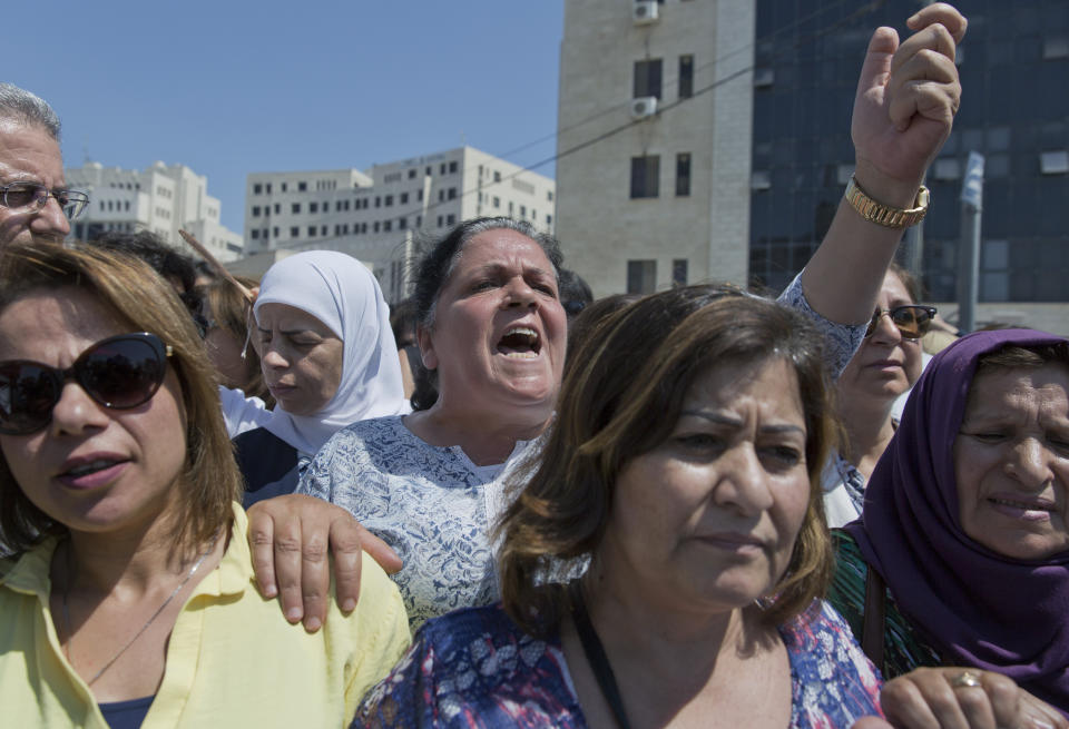 A Palestinian woman chants slogans during a rally in front of the Prime Minister's office, in the West Bank city of Ramallah, Monday, Sept. 2. 2019. Hundreds of Palestinian women have protested in front of the prime minister's office to demand an investigation into the death of Israa Ghrayeb, a 21-year-old woman whom many suspect was the victim of a so-called honor killing. (AP Photo/Nasser Nasser)