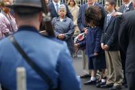 Denise Richard (2nd R), mother of 2013 Boston Marathon bombing victim Martin Richard, leans over her daughter Jane (3rd R) while standing beside her son Henry during a wreath-laying ceremony at the site of the first bomb blast near the finish line in Boston, Massachusetts April 15, 2014. REUTERS/Brian Snyder