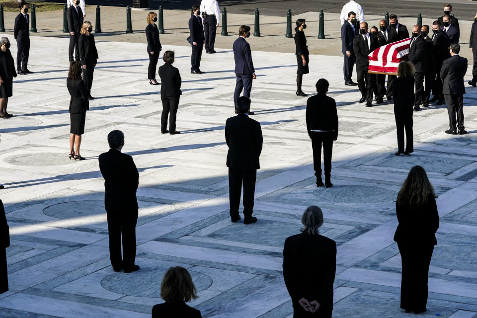 Supreme Court police carry Ginsburg's flag-draped casket up the steps of the Supreme Court. Six of Ginsburg's current clerks and five former clerks served as honorary pallbearers, according to a press release. / Credit: ALEX BRANDON/POOL/AFP via Getty Images