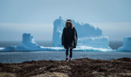 FILE PHOTO: A resident views the first iceberg of the season as it passes the South Shore, also known as "Iceberg Alley", near Ferryland Newfoundland, Canada April 16, 2017. REUTERS/Greg Locke