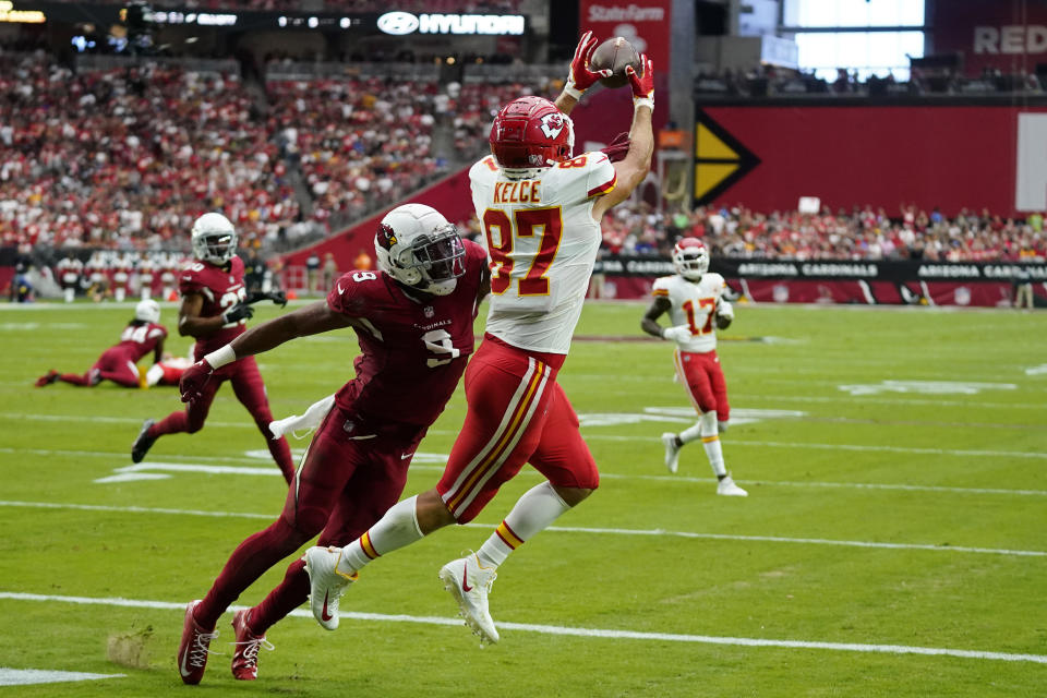 Kansas City Chiefs tight end Travis Kelce (87) catches a pass for a touchdown against Arizona Cardinals linebacker Isaiah Simmons (9) during the first half of an NFL football game, Sunday, Sept. 11, 2022, in Glendale, Ariz. (AP Photo/Ross D. Franklin)