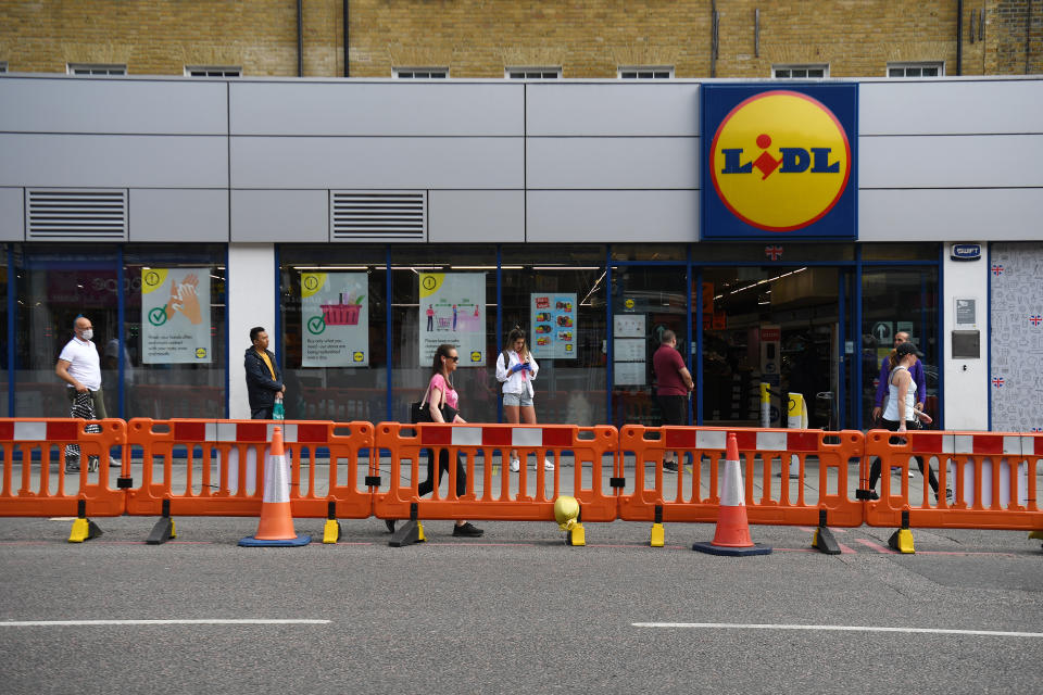 People make use of a new widened pavement to aid social distancing on Camden High Street in London, as the UK continues in lockdown to help curb the spread of the coronavirus.