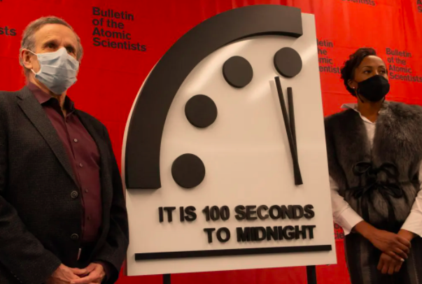 Members of the Bulletin of the Atomic Scientists' Science and Security Board, Robert Rosner and Suzet McKinney, reveal the 2021 setting of the Doomsday Clock: It is still 100 seconds to midnight.  / Credit: Bulletin of the Atomic Scientists/Thomas Gaulkin