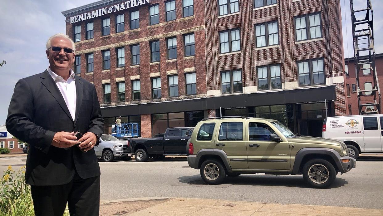 Real estate developer Tony Cordeiro in front of one of two completed downtown market rate housing projects last summer.