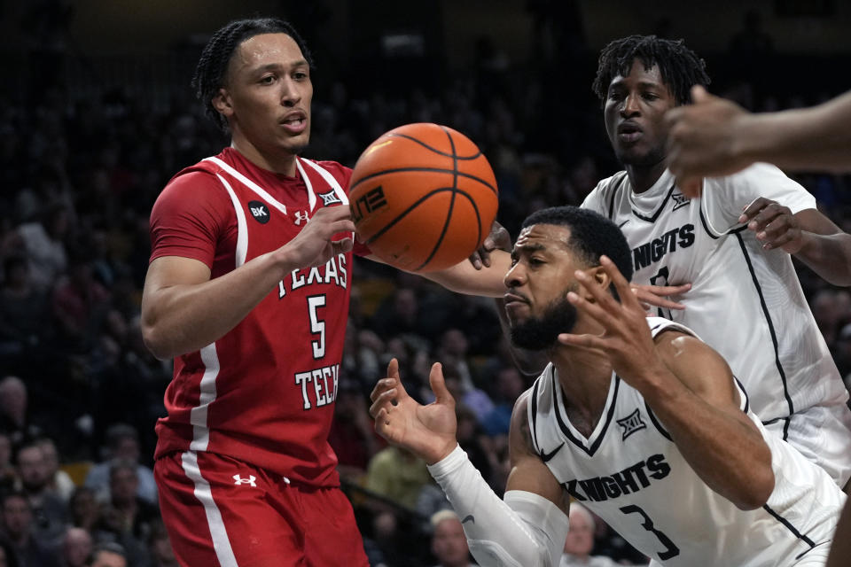 Central Florida guard Darius Johnson (3) grabs a rebound in front of Texas Tech guard Darrion Williams (5) during the second half of an NCAA college basketball game, Saturday, Feb. 24, 2024, in Orlando, Fla. (AP Photo/John Raoux)