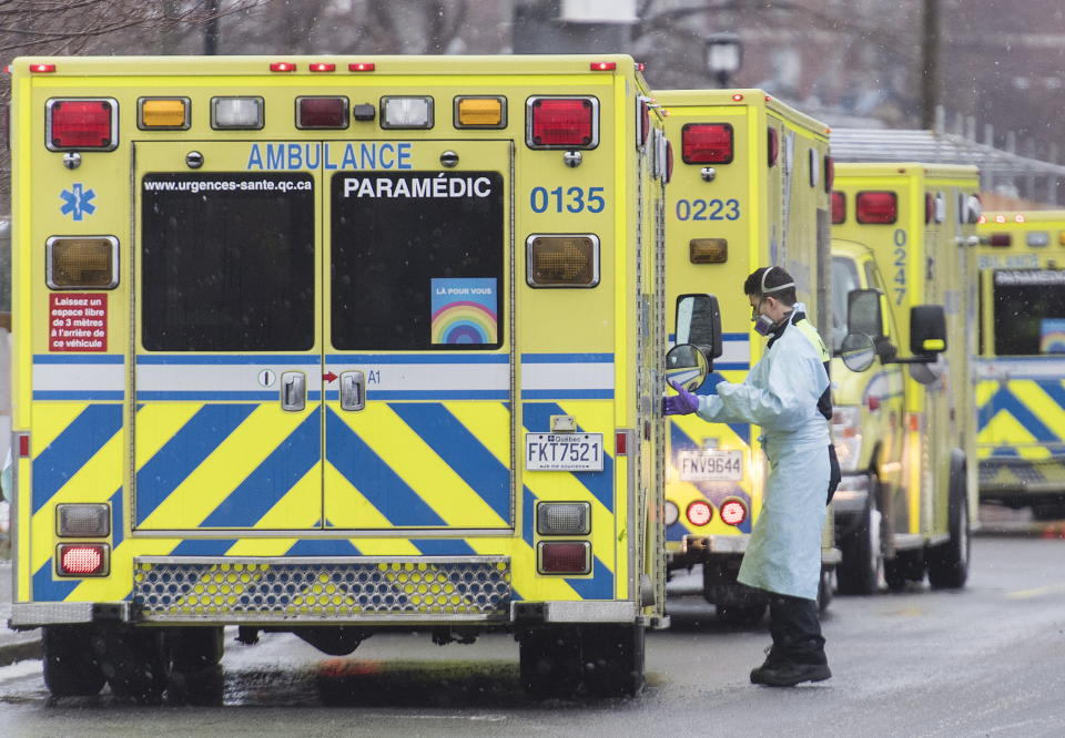 A paramedic is shown next to an ambulance outside a hospital in Montreal, Monday, Dec. 28, 2020, as the COVID-19 pandemic continues in Canada and around the world. (Graham Hughes/The Canadian Press via AP)