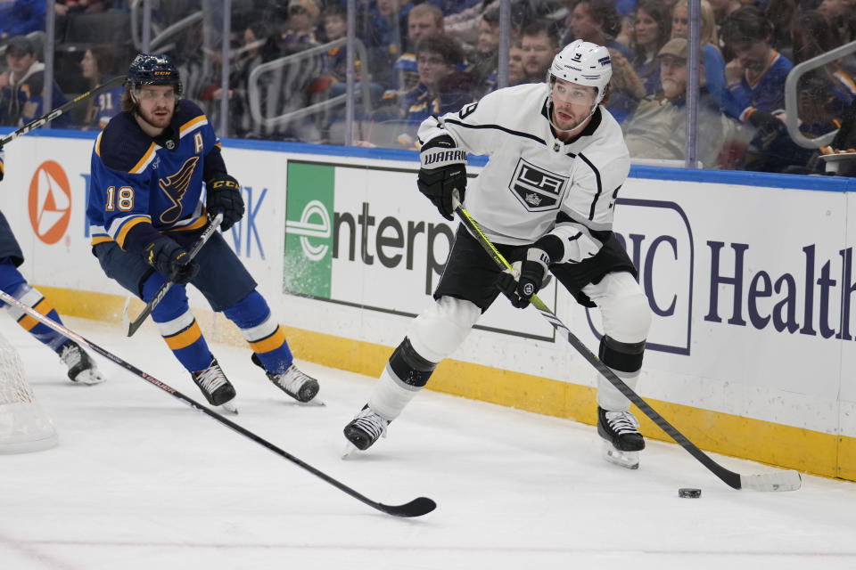 Los Angeles Kings' Adrian Kempe (9) looks to pass as St. Louis Blues' Robert Thomas (18) defends during the first period of an NHL hockey game Sunday, Jan. 28, 2024, in St. Louis. (AP Photo/Jeff Roberson)