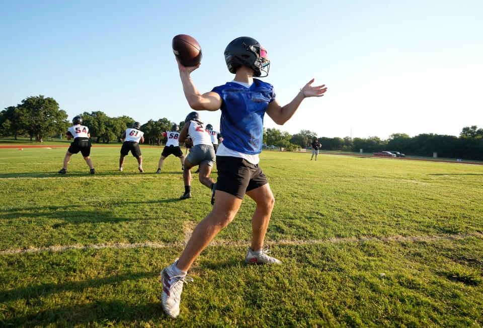 Bowie quarterback Cruz Tello passes during drills on Monday, the first day of high school football practice around the state. Tello, a senior and returning starter, said he's eagerly looking forward to the Bulldogs' season opener on Aug. 30. 