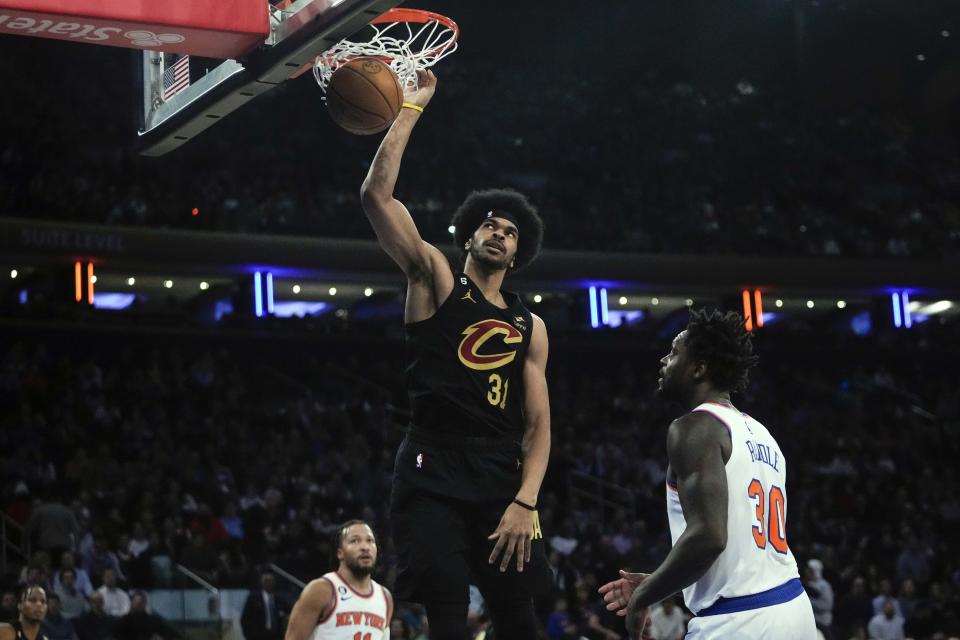 Cleveland Cavaliers' Jarrett Allen (31) dunks the ball in front of New York Knicks' Julius Randle (30) during the first half of an NBA basketball game Tuesday, Jan. 24, 2023, in New York. (AP Photo/Frank Franklin II)