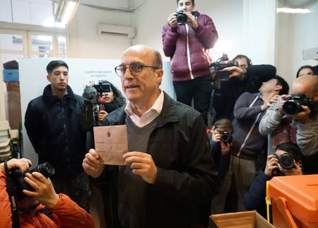 Former mayor of Montevideo Daniel Martinez of the Frente Amplio party poses for photographers before casting his vote during primary elections ahead of the presidential elections later this year, in Montevideo