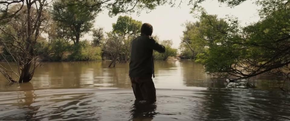 Sharlto Copley's character tracking lion in the water in Beast