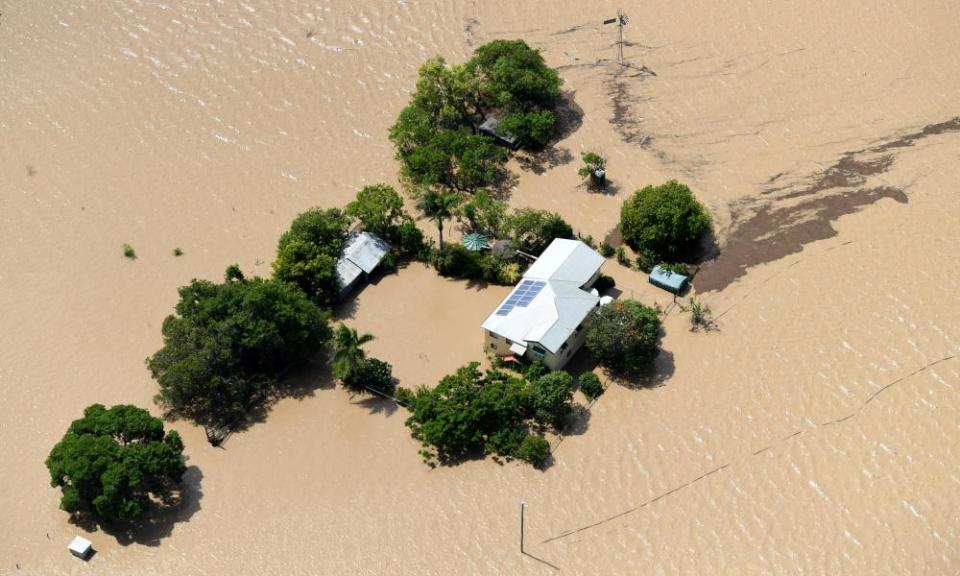 A property is surrounded by flood waters caused by Cyclone Debbie near Rockhampton .