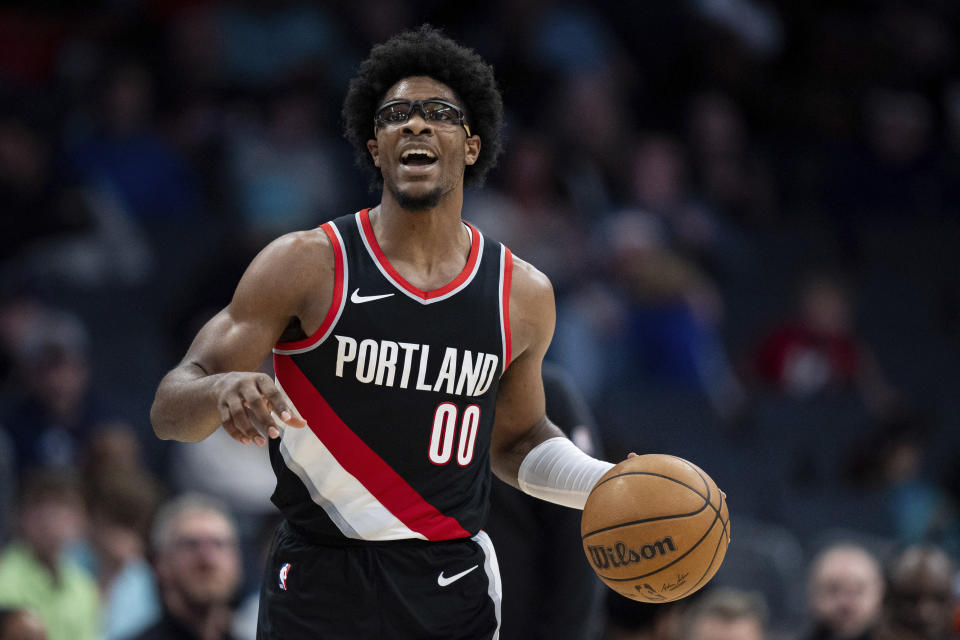 Portland Trail Blazers guard Scoot Henderson brings the ball upcourt during the second half of an NBA basketball game against the Charlotte Hornets Wednesday, April 3, 2024, in Charlotte, N.C. (AP Photo/Jacob Kupferman)