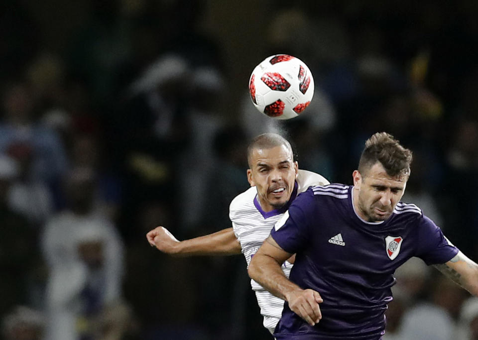 Emirates's Al Ain Ismail Ahmed, left, jumps for the ball with Argentina's River Plate Lucas Pratto during the Club World Cup semifinal soccer match between Al Ain Club and River Plate at the Hazza Bin Zayed stadium in Al Ain, United Arab Emirates, Tuesday, Dec. 18, 2018. (AP Photo/Hassan Ammar)
