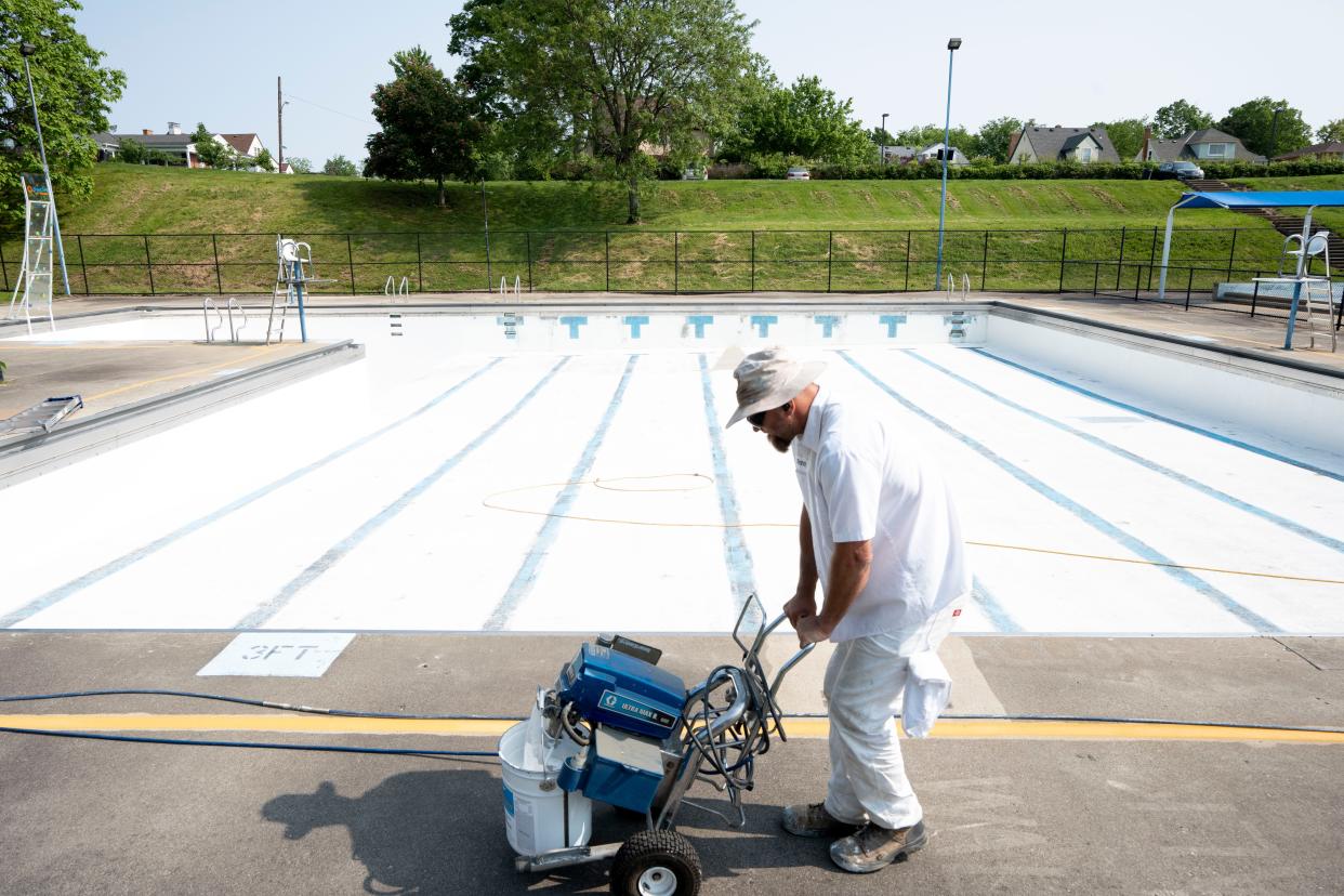 An employee of Cincinnati Recreation Commission resurfaces Ryan Pool in Westwood in May 2023.