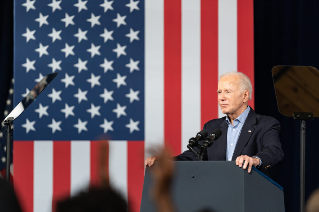 President Joe Biden at lectern with U.S. flag behind him.