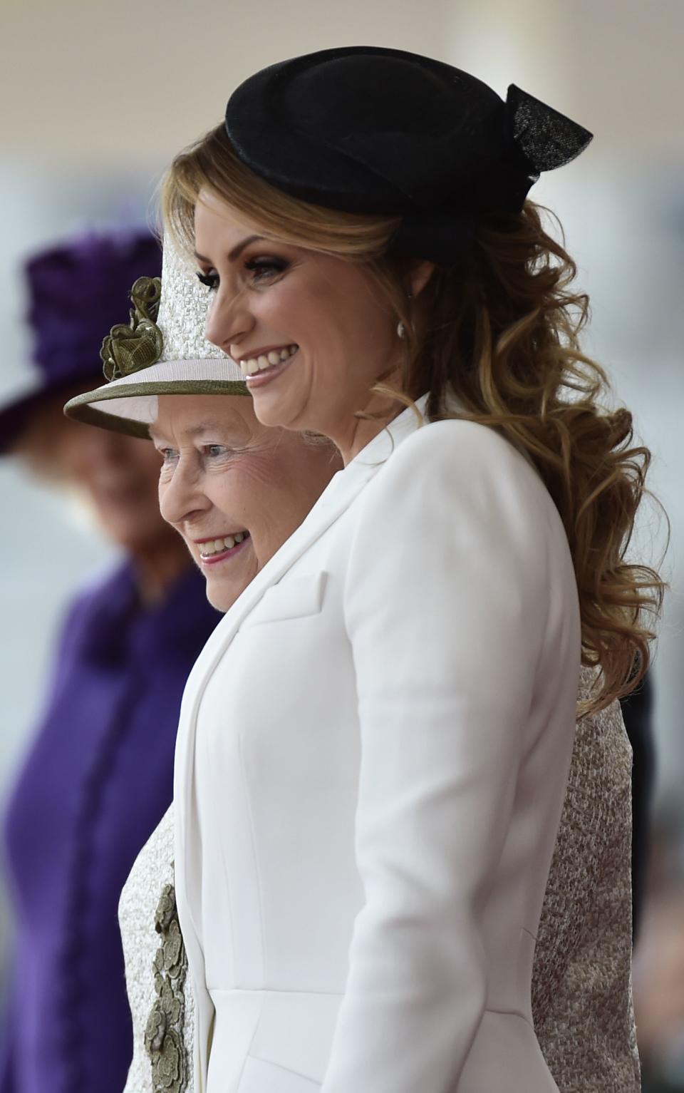 Britain's Queen Elizabeth smiles as she stands with Angelica Rivera the wife of Mexico's President Enrique Pena Nieto during a ceremonial welcome at Horse Guards Parade in London