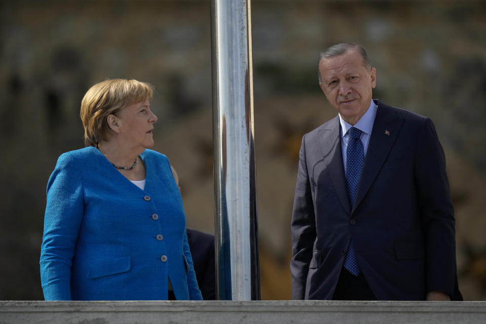 German Chancellor Angela Merkel, left, talks to Turkish President Recep Tayyip Erdogan on the occasion of their meeting at Huber Villa presidential palace, in Istanbul, Turkey, Saturday, Oct. 16, 2021. (AP Photo/Francisco Seco)