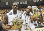 Wichita State's Chadrack Lufile, left, and Nick Wiggins celebrate their perfect 31-0 season after defeating Missouri State 68-45 in an NCAA college basketball game in Wichita, Kan., Saturday, March 1, 2014. (AP Photo/The Wichita Eagle, Fernando Salazar) LOCAL TV OUT; MAGS OUT; LOCAL RADIO OUT; LOCAL INTERNET OUT