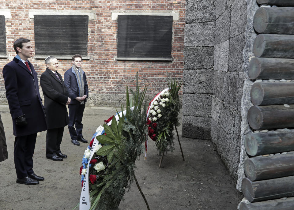 White House Senior Adviser Jared Kushner, left, stands in front of wreaths at a death wall during a visit at the Nazi concentration camp Auschwitz-Birkenau in Oswiecim, Poland, Friday, Feb. 15, 2019. (AP Photo/Michael Sohn)