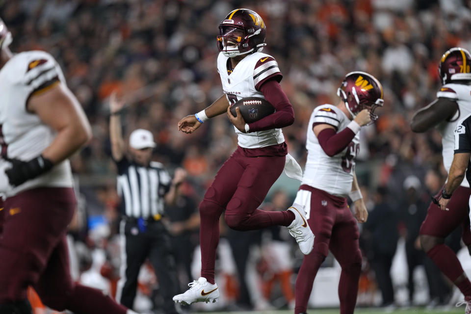 Washington Commanders quarterback Jayden Daniels celebrates after throwing a touchdown pass during the second half of an NFL football game against the Cincinnati Bengals, Monday, Sept. 23, 2024, in Cincinnati. (AP Photo/Carolyn Kaster)