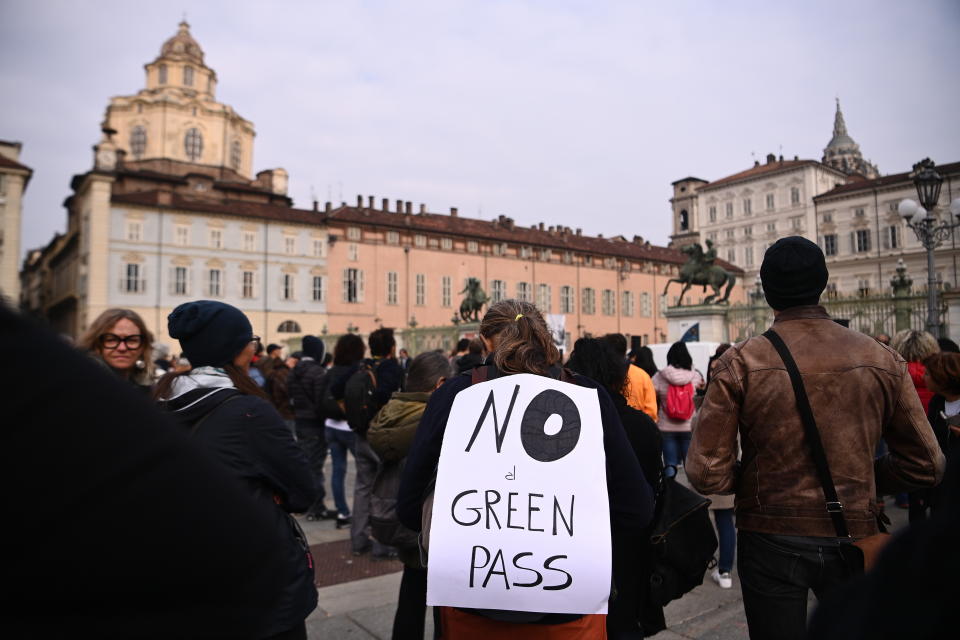 People gather and stage a No Green Pass protest in Turin, Italy, Friday, Oct. 15, 2021. Protests erupted in Italy on Friday as one of the most stringent anti-coronavirus measures in Europe went into effect, requiring all workers, from magistrates to maids, to show a health pass to get into their place of employment. The so-called “Green Pass” shows proof of vaccination, a recent negative test or of having recovered from COVID-19 in the past six months. Italy has required it to access all sorts of indoor activities for weeks, including dining , visiting museums and theaters and on long-distance trains. (Marco Alpozzi/LaPresse via AP)