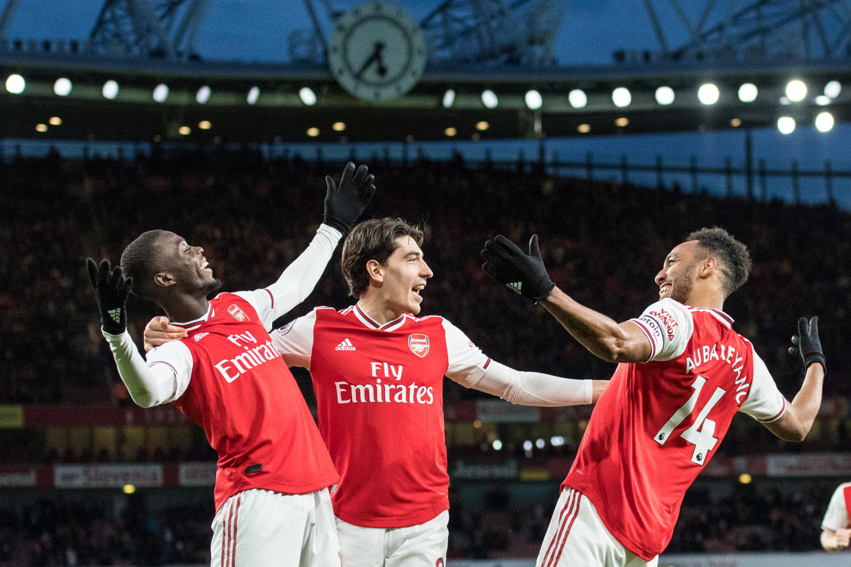 Arsenal's Pierre-Emerick Aubameyang (right) celebrates his winning goal with teammates Nicolas Pépé (left) and Héctor Bellerín on Sunday. (Photo by Sebastian Frej/MB Media/Getty Images)