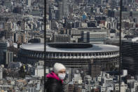 FILE - In this March 3, 2020, file photo, the New National Stadium, a venue for the opening and closing ceremonies at the Tokyo 2020 Olympics, is seen from Shibuya Sky observation deck in Tokyo. Organizers and the International Olympic Committee are pushing on despite COVID-19 risks, myriad scandals, and overwhelming public opposition in Japan to holding the games. (AP Photo/Jae C. Hong, File)