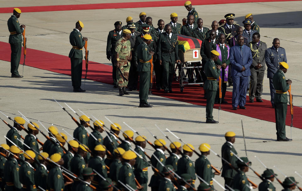 A coffin carrying the remains of Zimbabwe's longtime ruler Robert Mugabe arrives from Singapore, at Robert Gabriel Mugabe International Airport in Harare, Zimbabwe, Wednesday, Sept. 11, 2019. The body of Mugabe is being flown to the capital, Harare, on Wednesday where it will be displayed at historic locations for several days before burial at a location still undecided because of friction between the ex-leader's family and the government. AP Photo/Themba Hadebe)