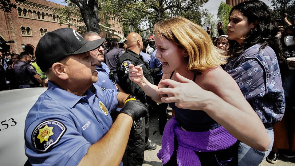 A University of Southern California protester, right, confronts a University Public Safety officer at the campus' Alumni Park during a pro-Palestinian occupation Wednesday in Los Angeles. - Richard Vogel/AP