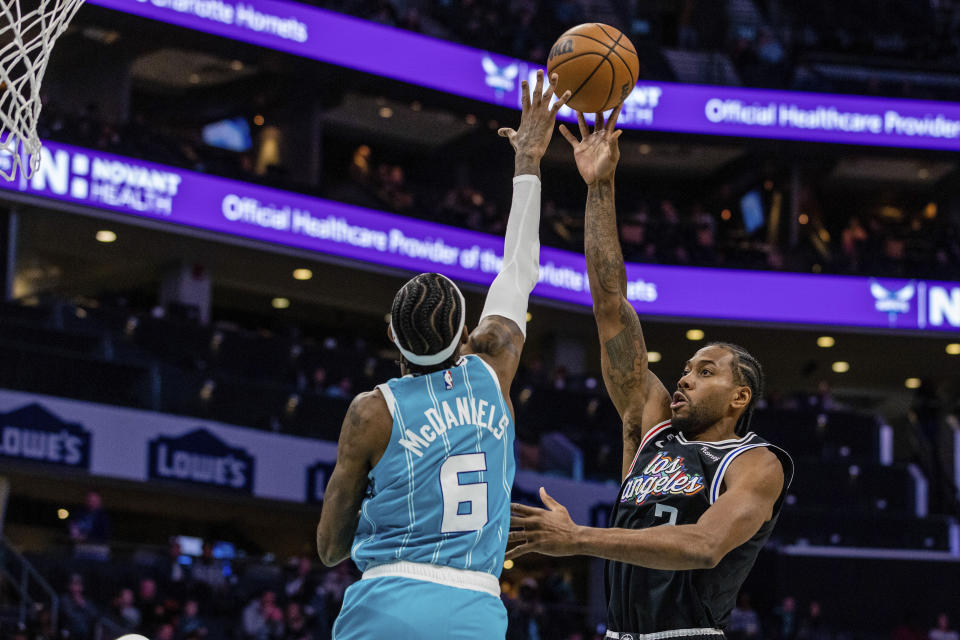 Charlotte Hornets forward Jalen McDaniels (6) guards the layup from LA Clippers forward Kawhi Leonard (2) during the first half of an NBA basketball game on Monday, Dec. 5, 2022, in Charlotte, N.C. (AP Photo/Scott Kinser)